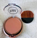 Devoted Creations Bronzing powder with a brush.