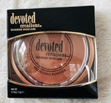 Devoted Creations Bronzing powder with a brush.